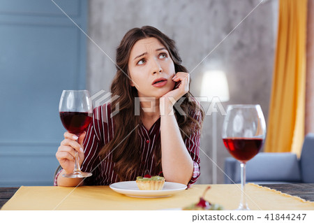 Depressed businesswoman talking to her friend during dinner 41844247