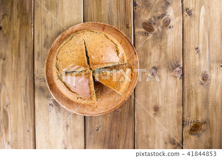 Homemade baking. Breakfast cake with poppy and citrus. Country style. Wooden background. Copy sapce Homemade baking. Breakfast cake with poppy and citrus. Country style. Wooden background. Copy sapce 41844853