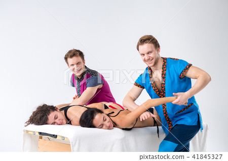 Theme massage and body care. Two young male twin brothers with a beard and uniform make a tandem 41845327