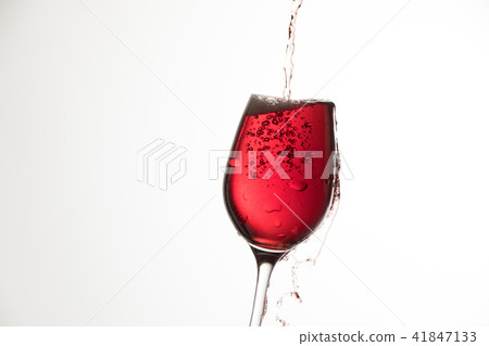 Pour the red wine into the glass Pour the red wine into the glass 41847133