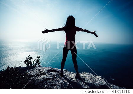 freedom female standing on sunrise windy coast freedom female standing on sunrise windy coast 41853118