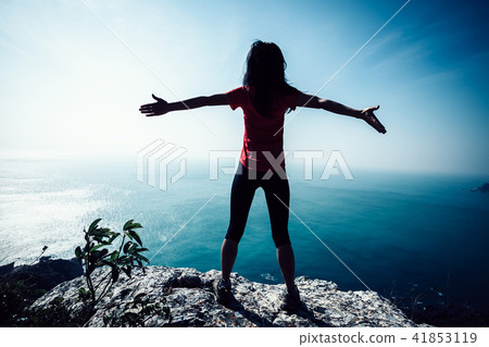 freedom female standing on sunrise windy coast freedom female standing on sunrise windy coast 41853119