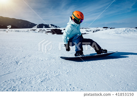one snowboarder snowboarding in winter mountains one snowboarder snowboarding in winter mountains 41853150