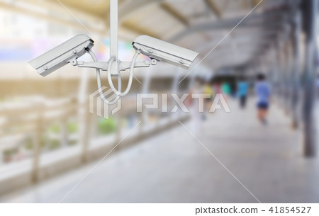 CCTV Camera surveillance operating with people on walk way 41854527