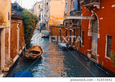 Venetian channel with ancient houses and boats Venetian channel with ancient houses and boats 41855642