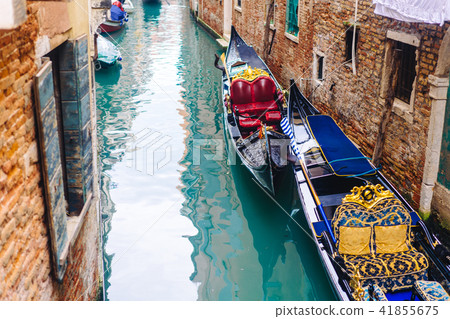 Venetian channel with ancient houses and boats Venetian channel with ancient houses and boats 41855675
