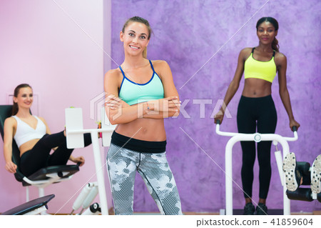 Portrait of beautiful woman working as fitness instructor in ladies only gym Portrait of beautiful woman working as fitness instructor in ladies only gym 41859604