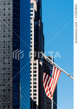 American flag waving against modern office building American flag waving against modern office building 41860601