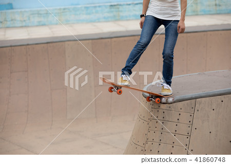 Skateboarder on skatepark ramp Skateboarder on skatepark ramp 41860748