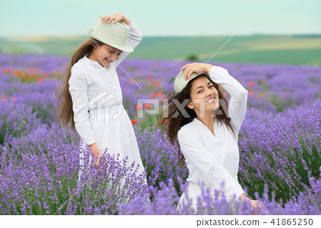 young woman and girl are in the lavender field young woman and girl are in the lavender field 41865250
