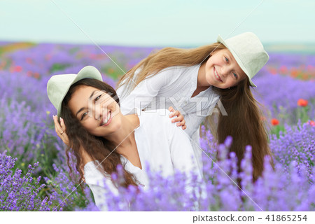young woman and girl are in the lavender field young woman and girl are in the lavender field 41865254