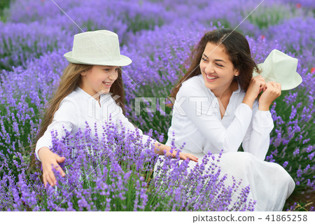 young woman and girl are in the lavender field young woman and girl are in the lavender field 41865258