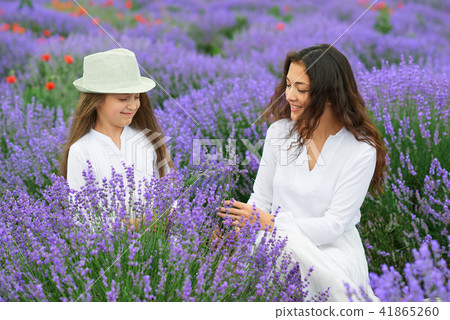 young woman and girl are in the lavender field young woman and girl are in the lavender field 41865260