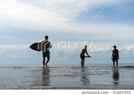 silhouette of a young man doing sports skimboard 41865956