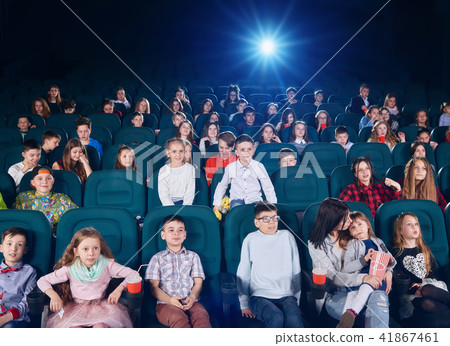 Children And Teens Watching Cartoon In Cinema Stock Photo