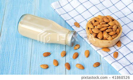 Almond milk on a blue wooden table. 41868526