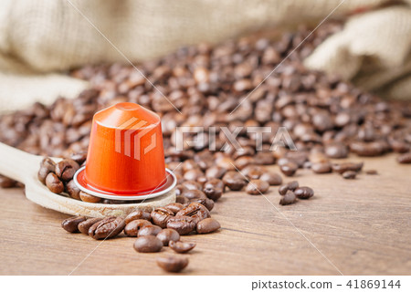 coffee capsule on wooden spoon coffee capsule on wooden spoon 41869144