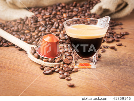 A cup of coffee and capsule coffee front view A cup of coffee and capsule coffee front view 41869146