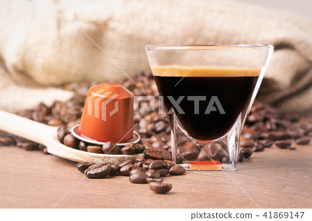 A cup of coffee and capsule coffee close up 41869147