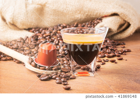 A cup of coffee roasted beans and capsule coffee 41869148