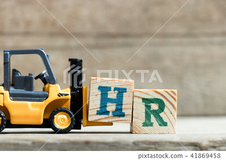 Toy yellow forklift hold letter block H to word HR 41869458