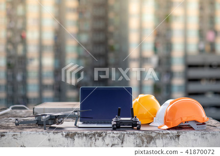 Drone, laptop and helmet at construction site Drone, laptop and helmet at construction site 41870072