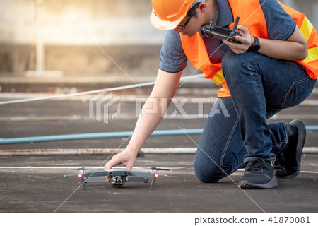 Asian engineer using drone at construction site 41870081