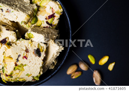 Halva with pistachio on dark background Halva with pistachio on dark background 41871605