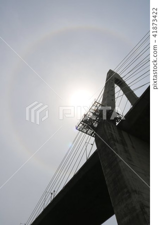 The sun wearing a sunset bridge and an umbrella 41873422
