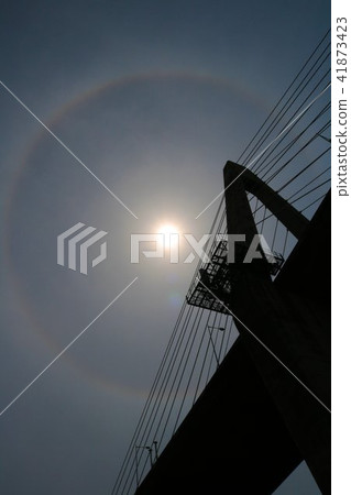 The sun wearing a sunset bridge and an umbrella 41873423