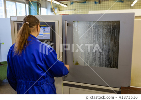 Woman in uniform in production 41873516