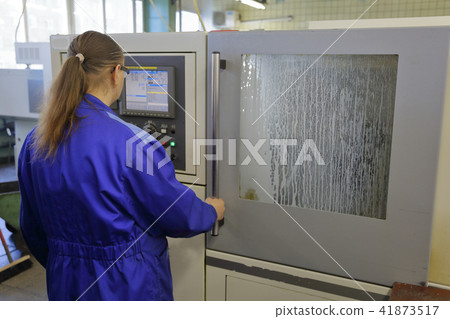 Woman in uniform in production 41873517