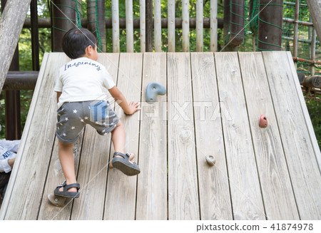 A boy playing in a park 41874978