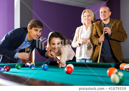 Group of friends playing billiards Group of friends playing billiards 41879339
