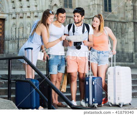 Group of young travellers searching for direction using map Group of young travellers searching for direction using map 41879340