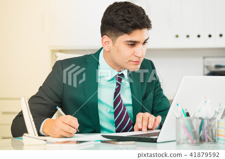 Young manager is working at a computer 41879592