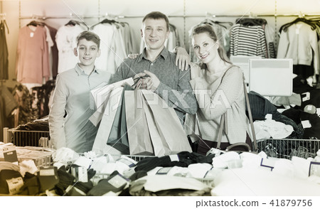 Woman, man and boy displaying purchase 41879756