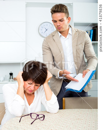 Mother and son sign documents 41879836