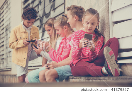 Five kids are playing on phone 41879837