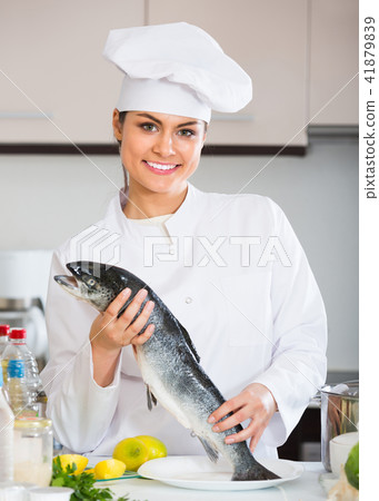 Female cook preparing big fish 41879839