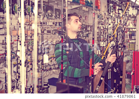 Fisherman customer choosing ocean fishing rod Fisherman customer choosing ocean fishing rod 41879861