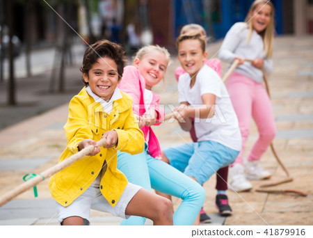 Cheerful children are competing and tug of war Cheerful children are competing and tug of war 41879916
