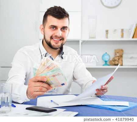 Young man struggling to pay utility bills and rent for his apartment 41879940