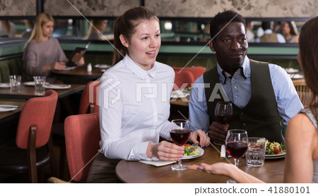 Couple with female friend in restaurant Couple with female friend in restaurant 41880101