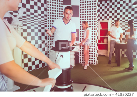 Five adults solving different conundrum in quest room 41880227