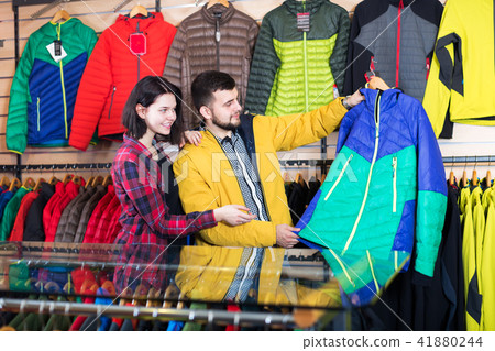 Couple examining windcheaters in store 41880244