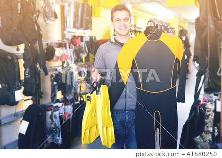 Smiling male standing with modern diving costumes and flippers 41880250