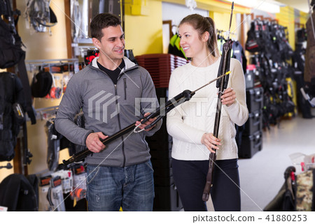 Man and woman are standing with modern speargun Man and woman are standing with modern speargun 41880253