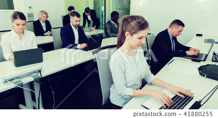 Business people working in open plan office Business people working in open plan office 41880255