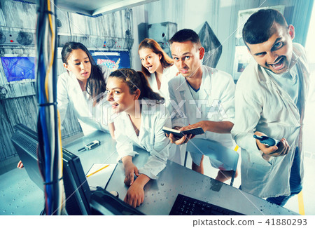 Adults laughing and grimacing in quest room-laboratory 41880293